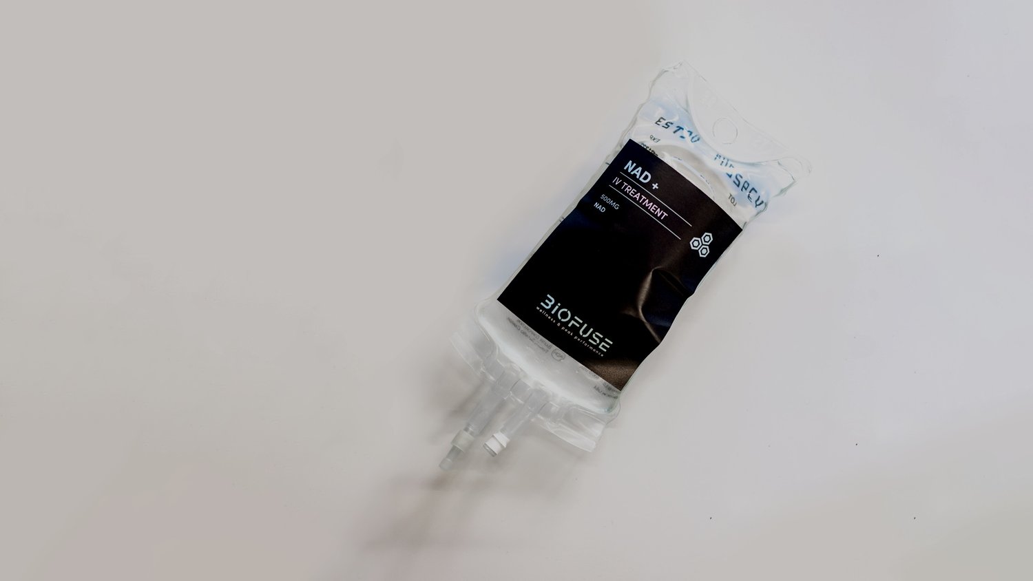 IV bag labeled 'NAD+' with drip tubing on a light background.